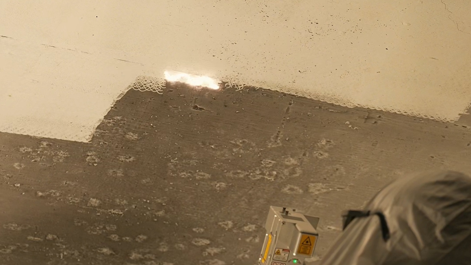 Commercial fire restoration using laser cleaning on steel beams in Richmond warehouse showing post-fire soot removal methods